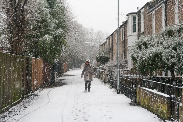 Woman walking through the snow along Ferry Path, Cambridge