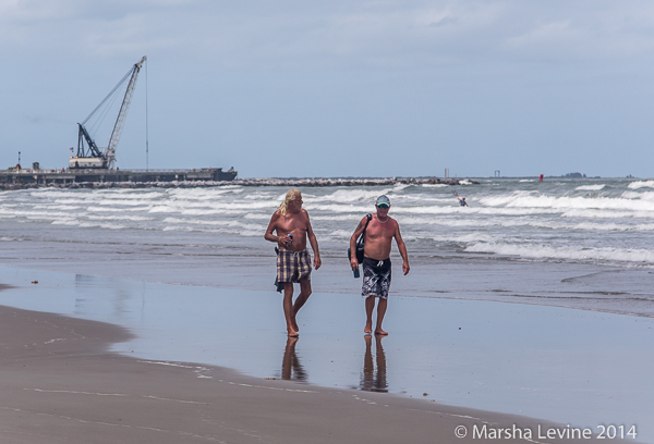 Two men walking along the beach at Jetty Park, Cape Canaveral