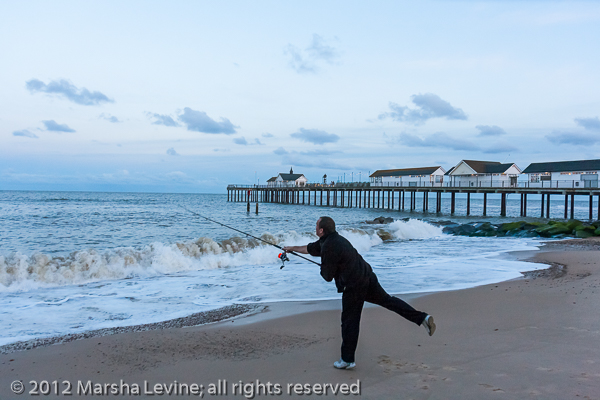 Fisherman casting his line near Southwold Pier, Suffolk (UK) 